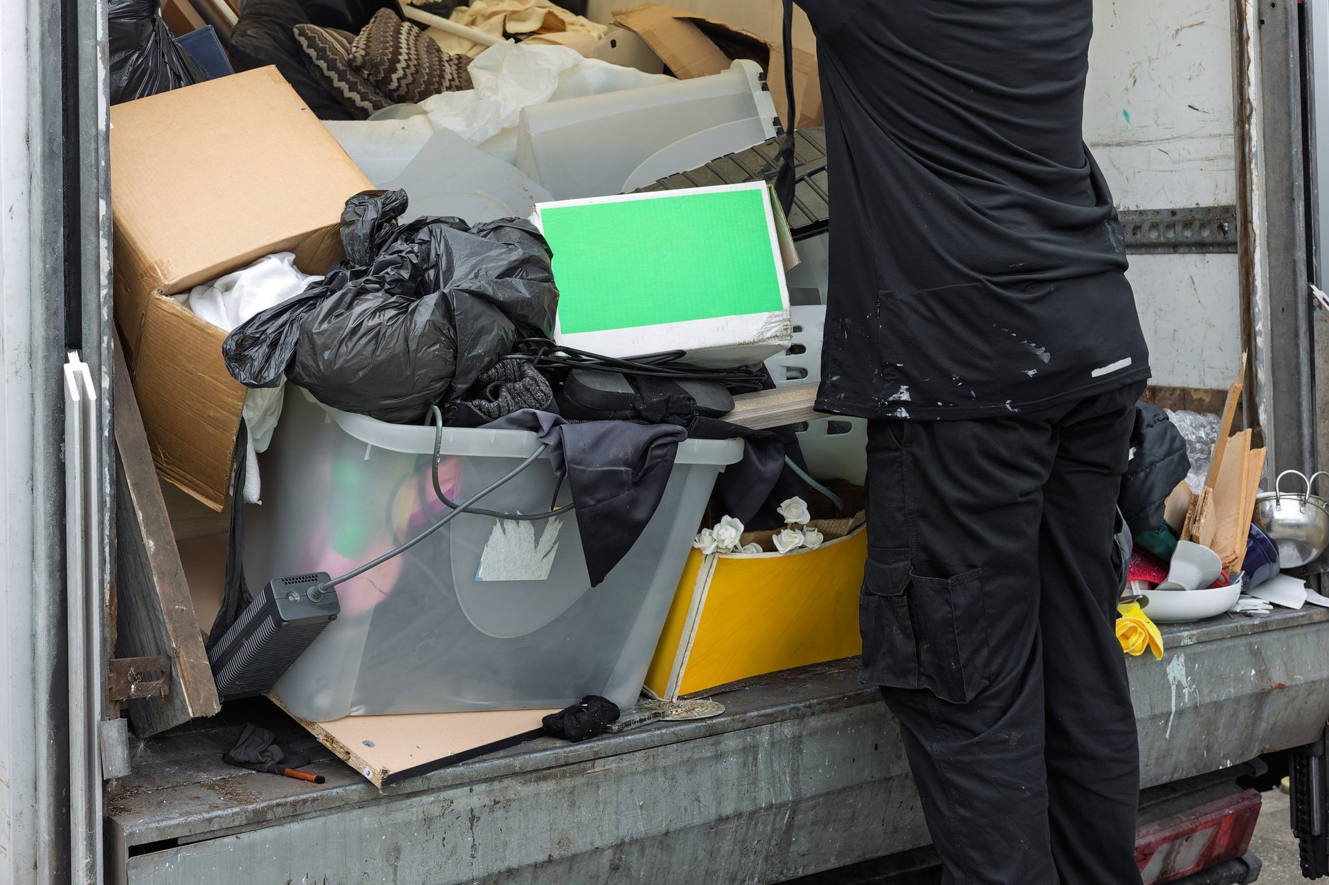 Worker unloading mixed waste from commercial truck
